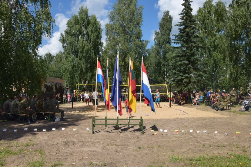 Troops of the NATO Battalion set up a beach volleyball court for Rukla residents